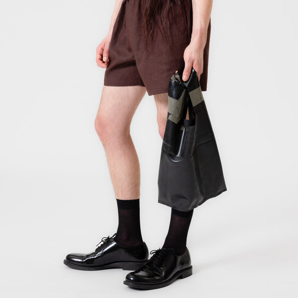 CHARCOAL black latex bag shaped like a classic plastic shopping bag with sculptural cutout handles by Dorilou